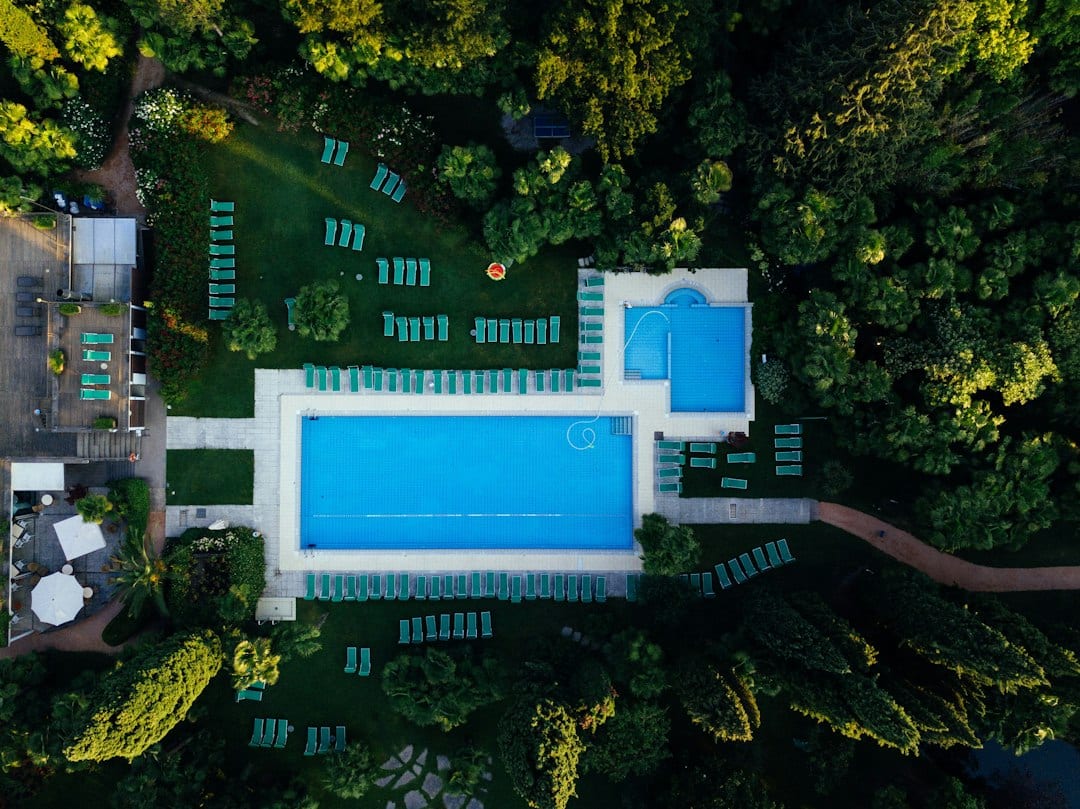 Resort-style pool deck overlooking forest reserve